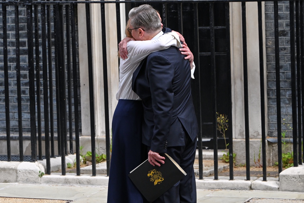 Starmer hugs his wife, Victoria, after he announced his resignation (AP)
