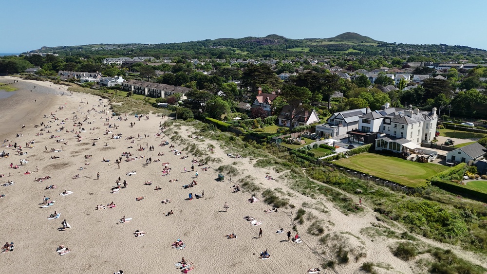 Sunbathers soak up the sunshine at Burrow Beach in Dublin as warm conditions continue under a Met Éireann yellow weather warning (Niall Carson/PA) (PA Wire)