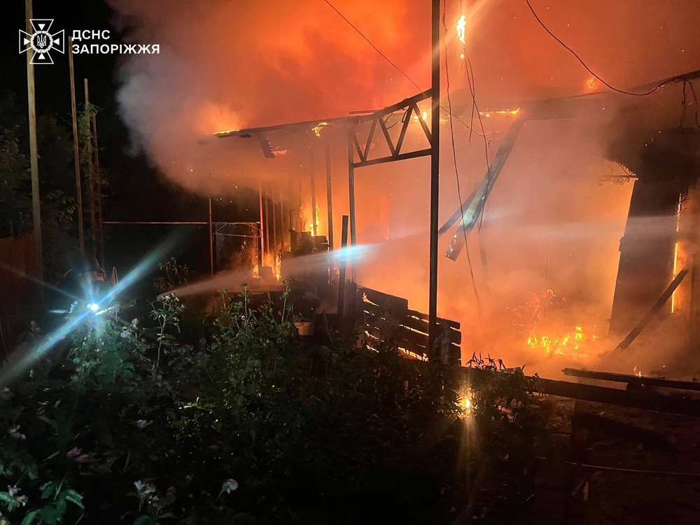 Emergency services personnel work to extinguish a fire following a Russian air attack in in Zaporizhzhia region (AP)