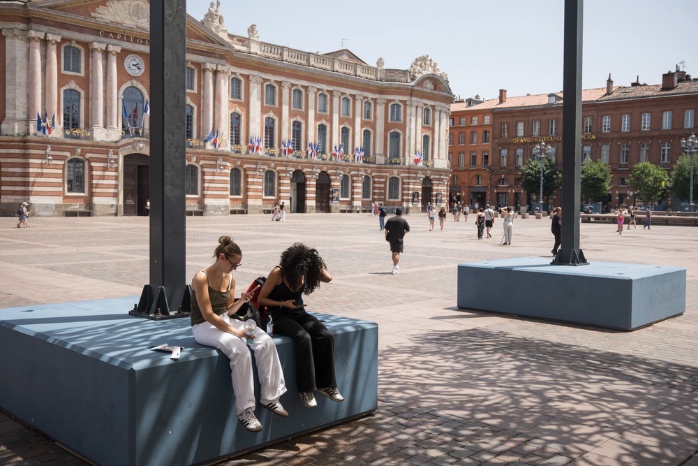 People sit in the shade in Toulouse during a heatwave on Monday (AFP/Getty)