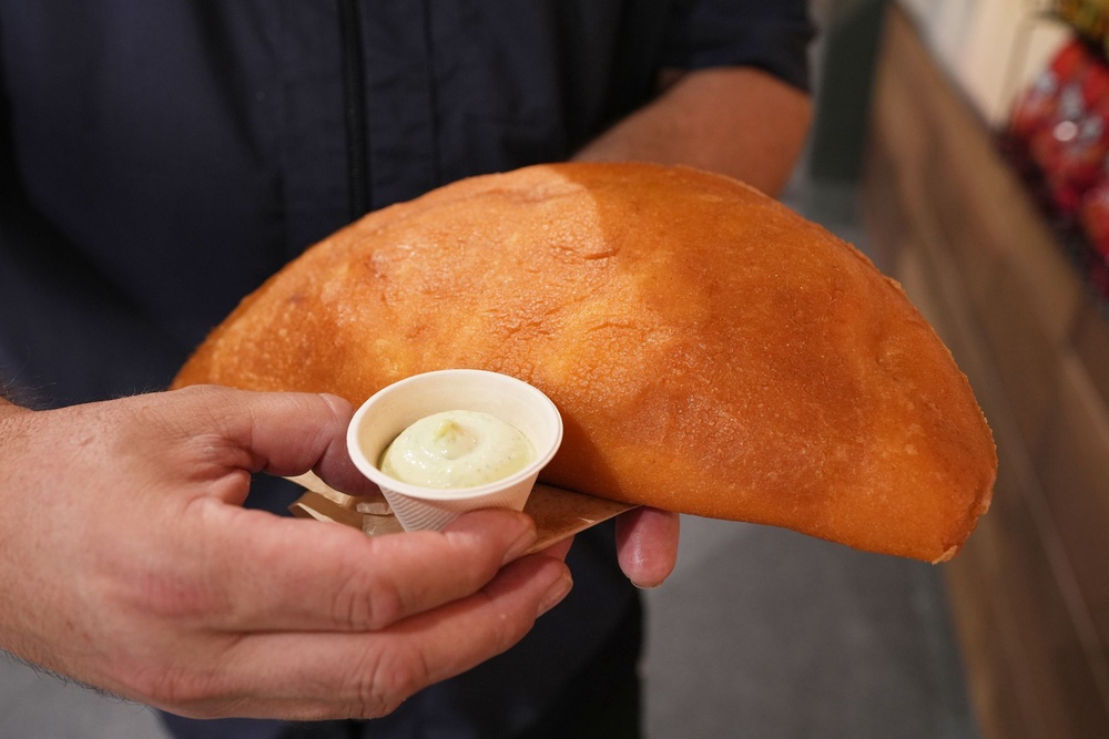 Lazaro Luya, the concession chef at Sol Cubano, displays their special, empanada mundial at Miami Stadium Sunday, June 21, 2026, in Miami Gardens, Fla. (AP)