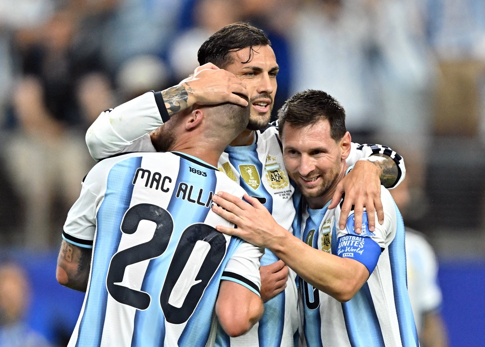 Messi celebrates against Austria with Leandro Paredes and Alexis Mac Allister (Reuters)