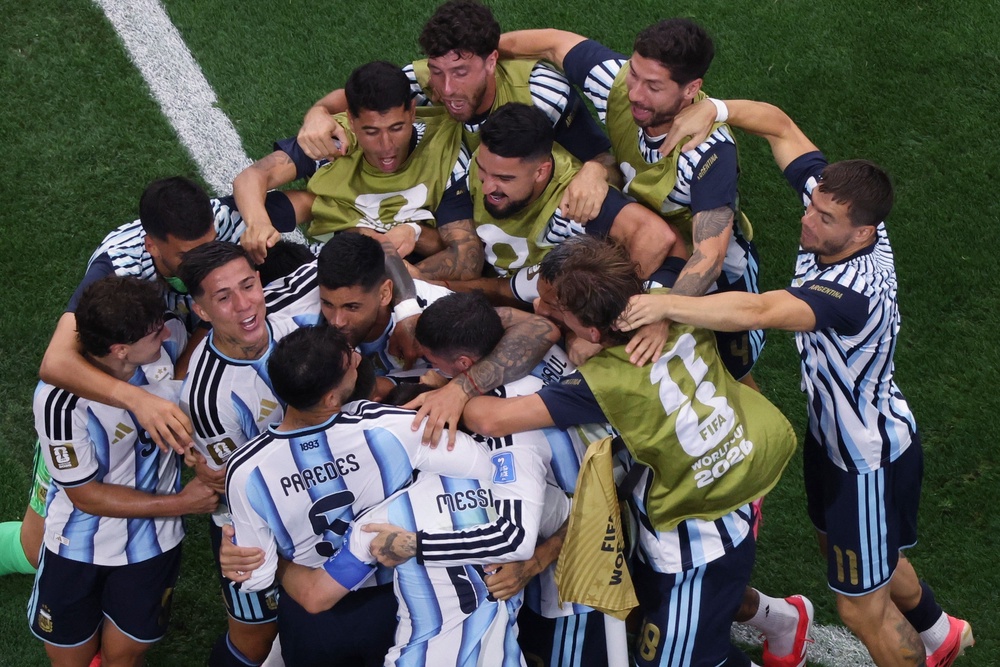 Argentina celebrate with Lionel Messi after clinching the game with a second goal (AP)