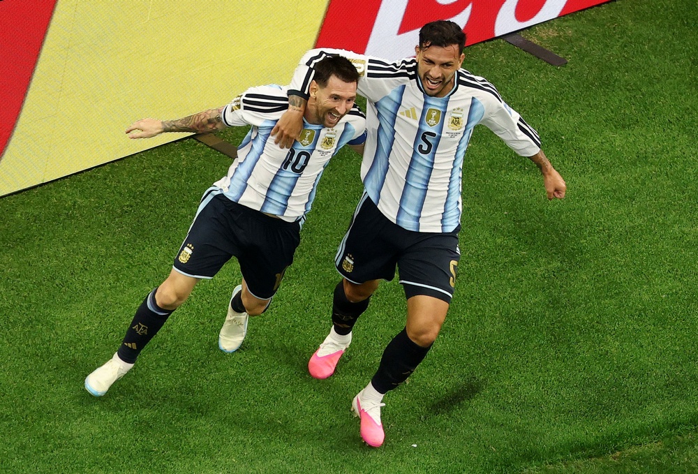 Lionel Messi of Argentina celebrates with teammate Leandro Paredes (Getty)
