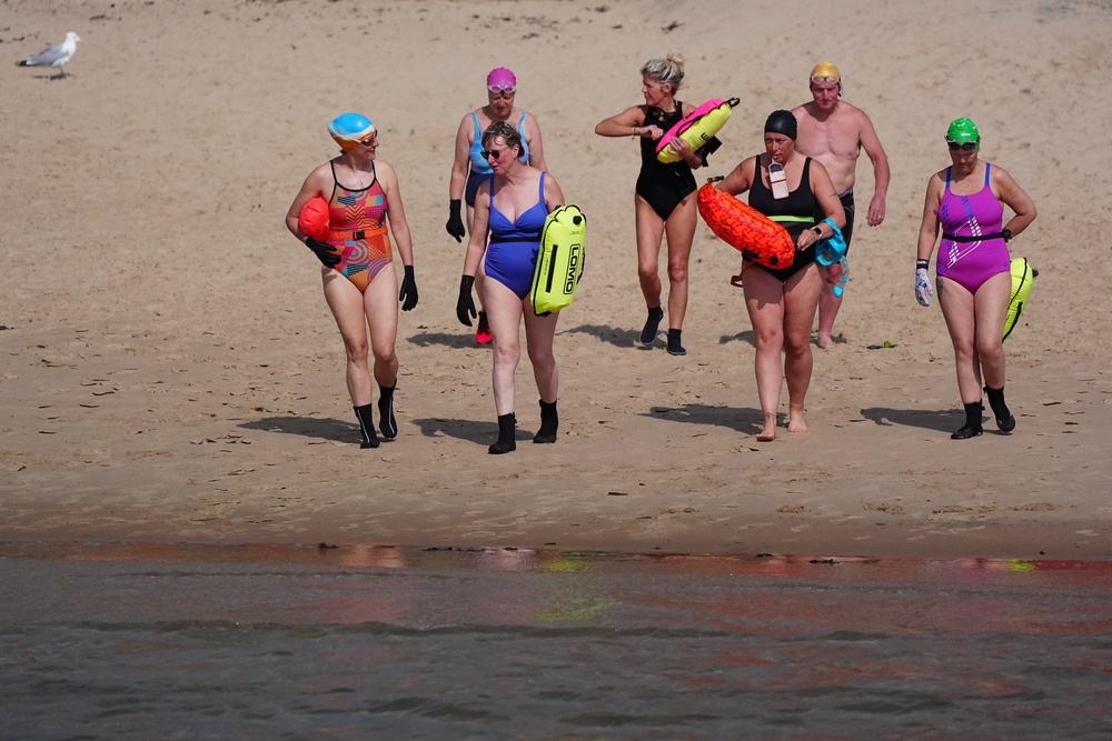 Swimmers at Cullercoats Bay, North Tyneside in the North East of England as temperatures are expected to soar to record-breaking levels (Owen Humphreys/PA) (PA Wire)