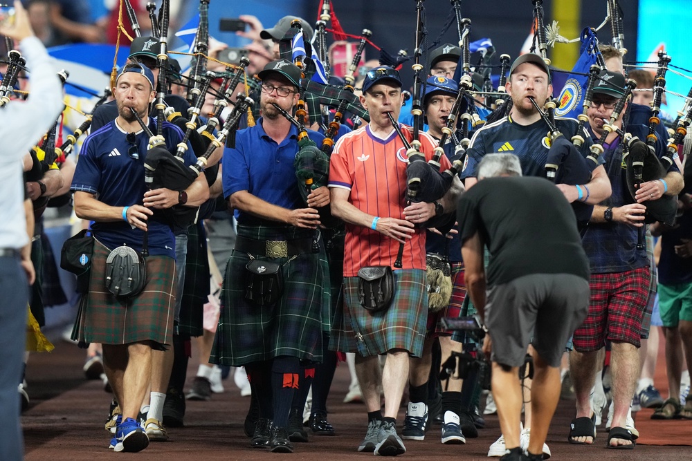 A bagpipe band marches in the outfield of LoanDepot Park in Miami. (AP)