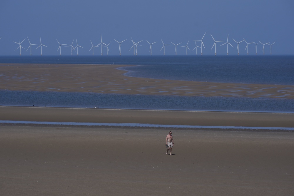 It was a perfect day for a walk on the beach for some (Peter Byrne/PA) (PA Wire)