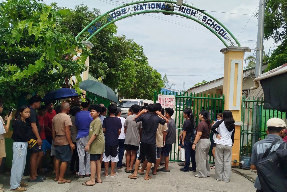 Three students were killed and 20 others were wounded when two suspects, ages 14 and 15, opened fire Monday at the San Jose National High School in central Tacloban city (AFP/Getty)