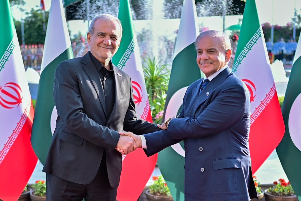 Iran’s president, Masoud Pezeshkian, (left) with Pakistan’s prime minister, Shehbaz Sharif (AP)