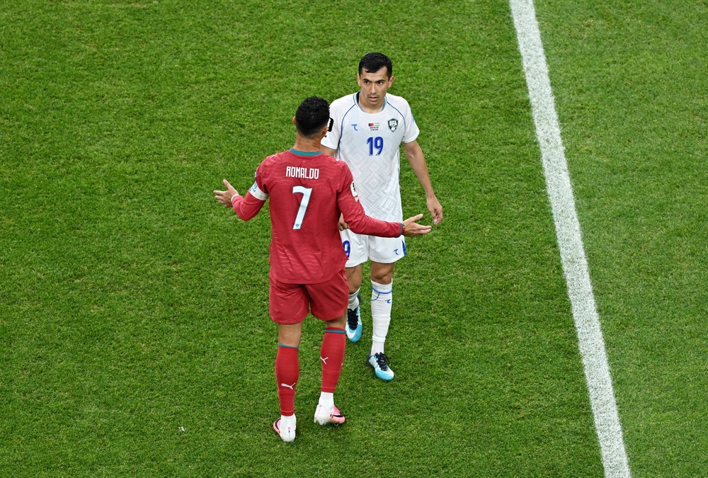 Uzbekistan's Azizjon Ganiev talks to Portugal's Cristiano Ronaldo after his goal was disallowed following a VAR review (Reuters)
