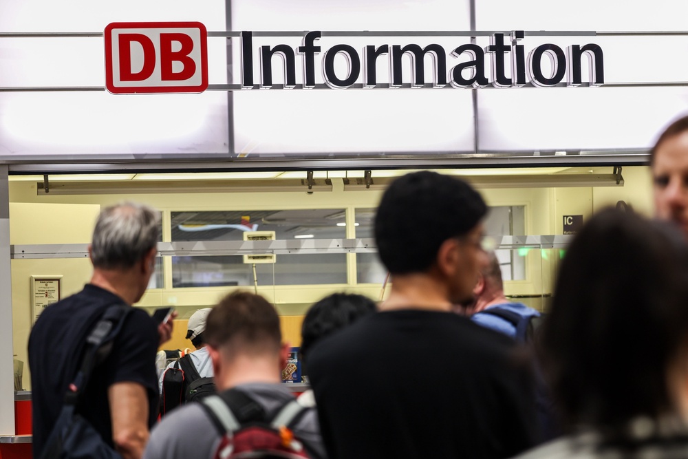 Passengers line up at the DB information desk at the Duisburg train station on Tuesday evening (DPA)