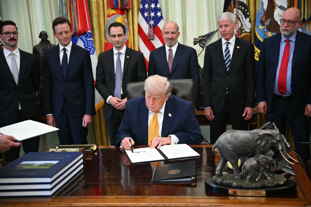 Donald Trump signs an executive order at the White House in June 2026 – he previously issued executive orders defining sex as strictly male or female at birth (AFP/Getty)