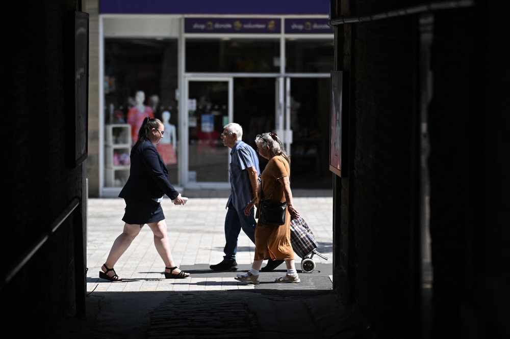 People walk through the town centre in Huddersfield in northern England on 23 June 2026 (AFP/Getty)