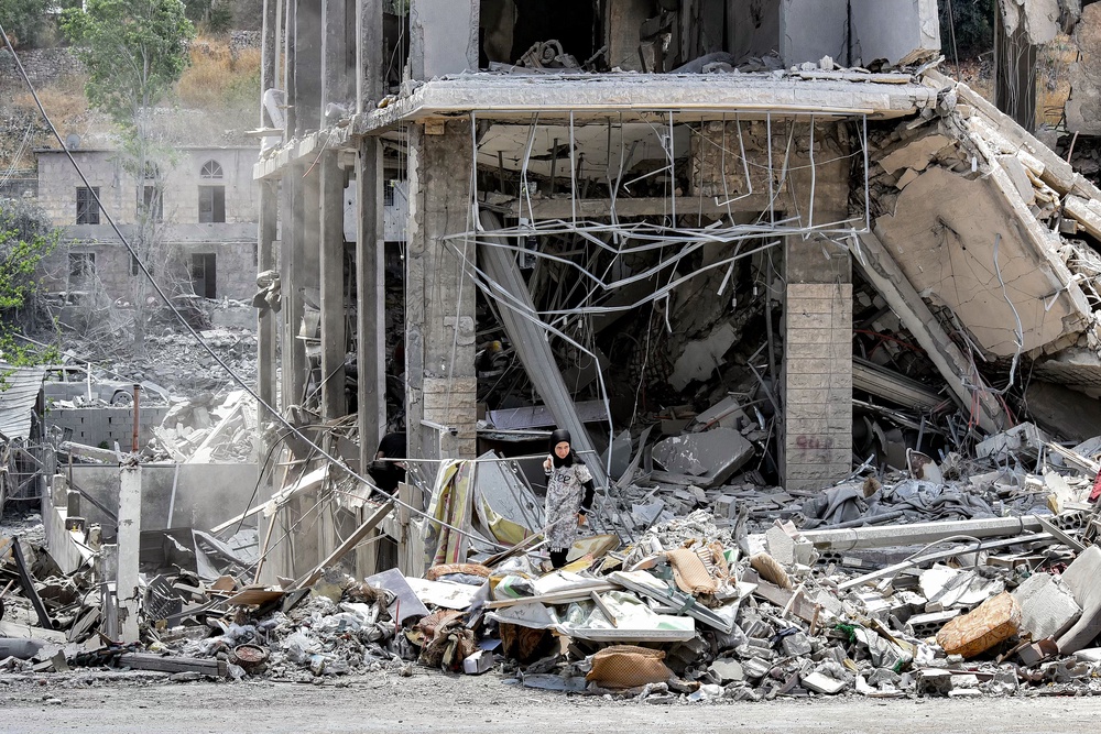 A woman inspects the rubble of a collapsed building in the town of Nabatieh al-Fawqa in southern Lebanon on June 23, 2026 (AFP/Getty)