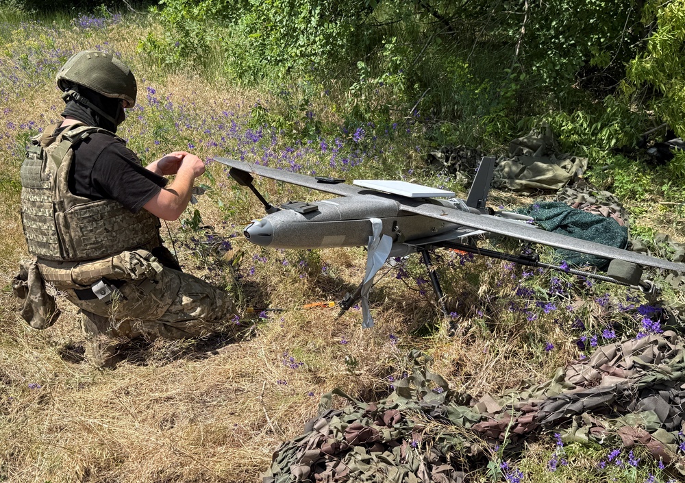 A serviceman of the 25th Separate Airborne Brigade of the Air Assault Forces of Ukraine prepares to launch a Hornet middle strike drone towards Russian troops (Reuters)