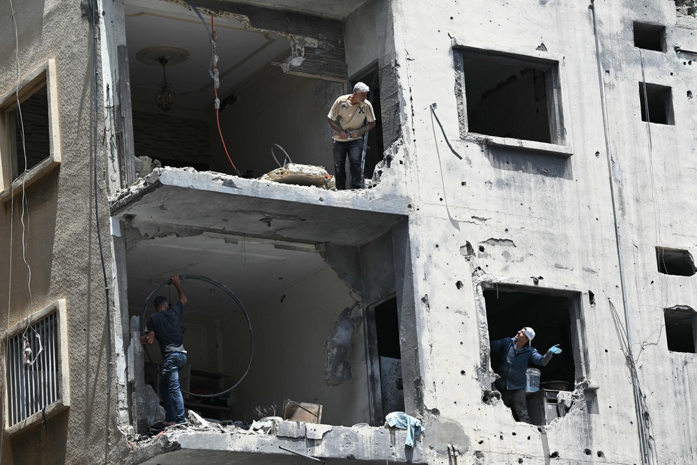 Construction workers remove debris in Tyre on Tuesday (AFP/Getty)