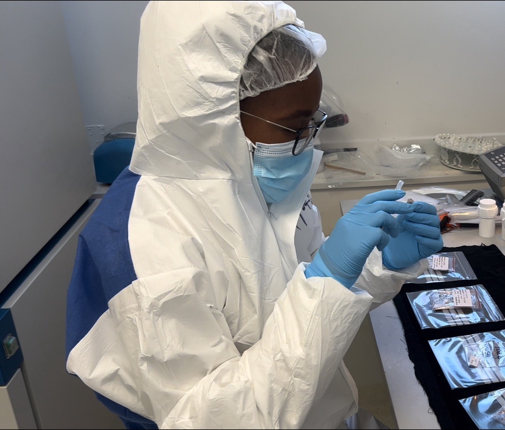 Scientist Palesa Madupe looking at specimens in the ancient biomolecules clean laboratory at the Globe Institute, University of Copenhagen. (Photo by Alberto Taurozzi)