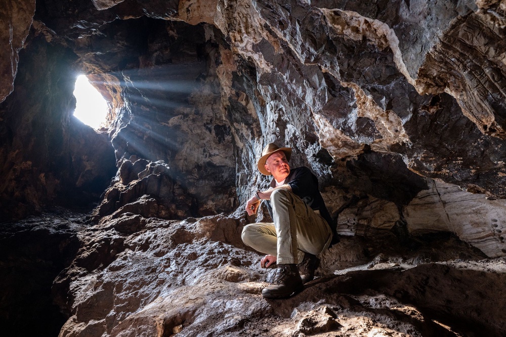 National Geographic Explorer in Residence and paleoanthropologist Lee Berger in an entrance chamber of Rising Star Cave in South Africa. (Photo by Robbie Shone/National Geographic)