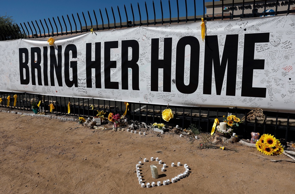 Candles and flowers are placed at a Nancy Guthrie memorial outside the KVOA newsroom in Tucson, Arizona (Getty)