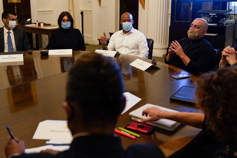 Then-New York City Mayor Eric Adams, center, speaks during a cabinet meeting on his first day in office in New York, Jan. 1, 2022. To Adams' right is his Chief of Staff Frank Carone (AP Photo/Seth Wenig)