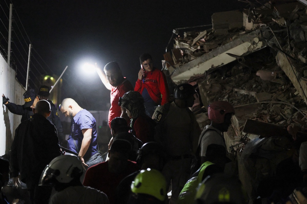 People inspect the site of a collapsed building after an earthquake in Caracas, Venezuela, 24 June 2026 (Reuters)