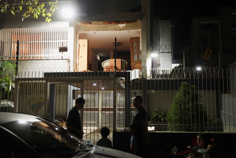 People gather outside a damaged building after an earthquake in Caracas, Venezuela, 24 June 2026 (Reuters)