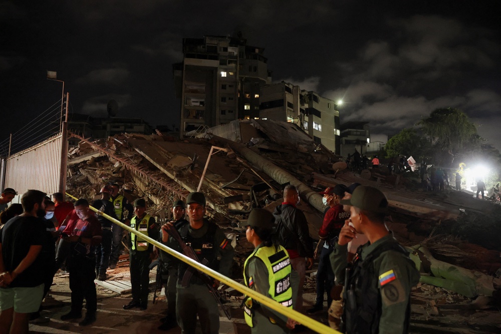 Members of the Bolivarian National Guard stand guard at the site of a collapsed building, which has been sealed off, after an earthquake in Caracas, Venezuela, 24 June 2026 (Reuters)