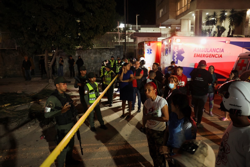 Members of the Bolivarian National Guard stand gurad at the site of a collapsed building, which has been sealed off, after an earthquake in Caracas, Venezuela, 24 June 2026 (Reuters)