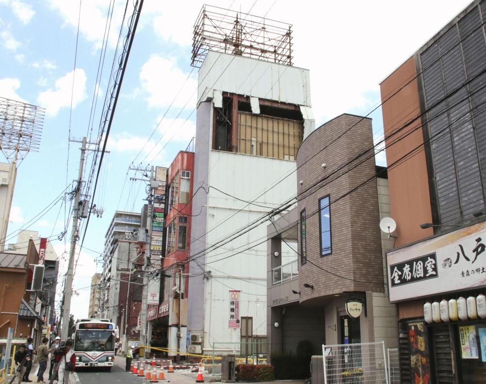 The wall of a building is partly damaged following an earthquake in Hachinohe, Aomori prefecture, Japan, on 25 June 2026 (AP)
