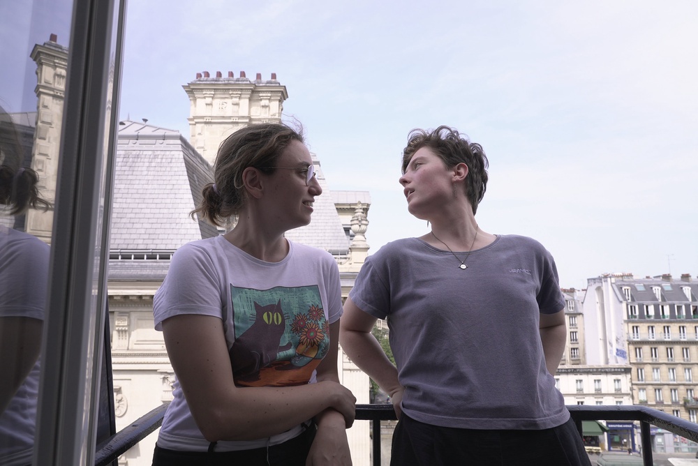 Amelie Kenney, right, and her partner Francesca Pilia stand on the balcony of the attic apartment they shares in Paris, Tuesday, June 23, 2026. (AP Photo/John Leicester) (AP)