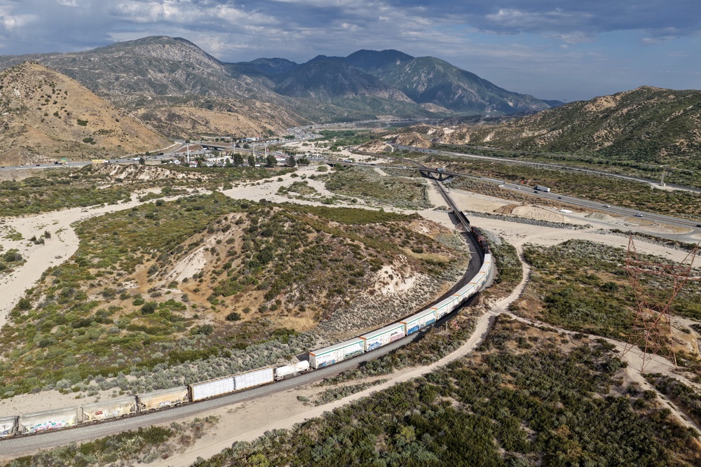 In an aerial view, a freight train is shown passing along the Cajon Pass near the San Andreas fault on June 23 (Getty)