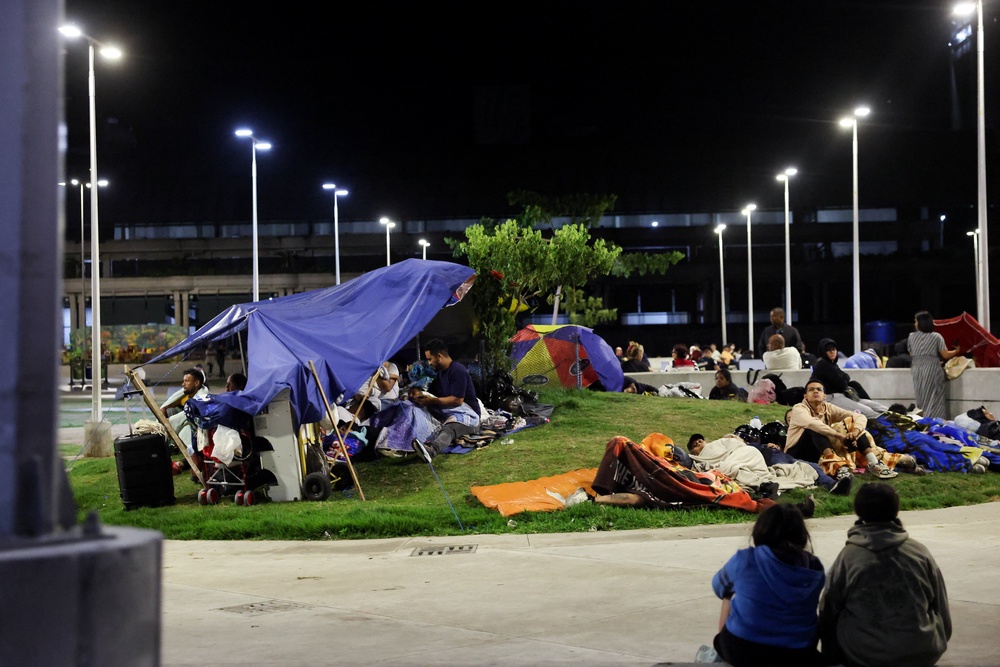 People rest in a square out of fear of going back into buildings, as emergency services (not pictured) work at the site of a collapsed building after earthquakes hit the country, in Caracas, Venezuela, June 25, 2026. (Reuters)
