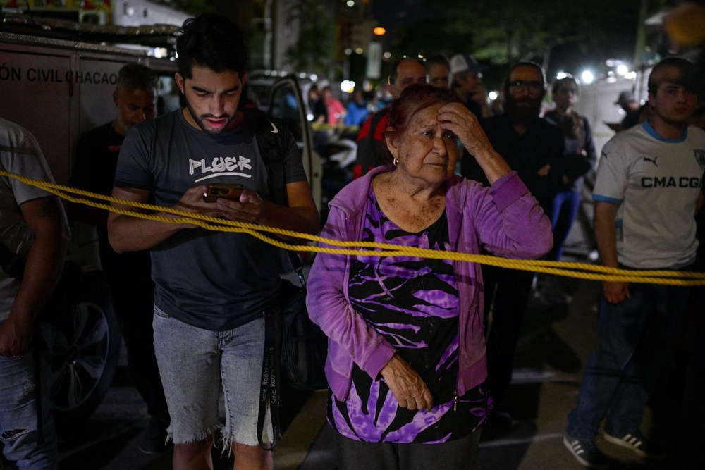 People stand at the site of a collapsed building, after an earthquake, in Caracas, Venezuela, June 25, 2026. (Reuters)