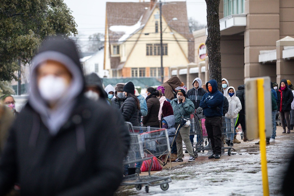 People queue up outside a grocery store in Austin during a cold snap in Texas on 17 February 2021 (Getty)