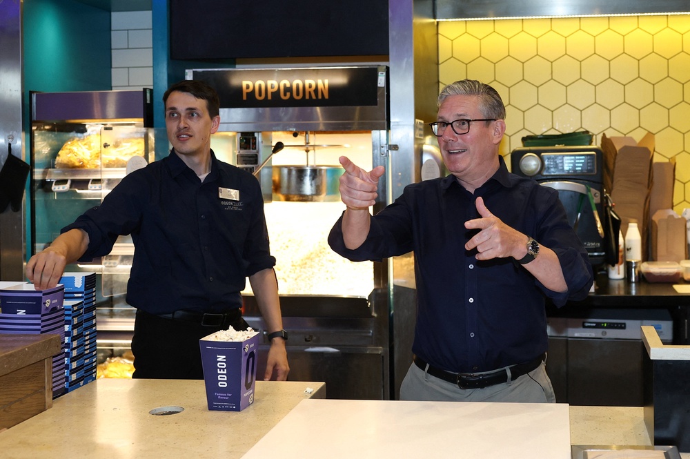 Sir Keir Starmer serving popcorn during a visit to a cinema in Milton Keynes (Toby Melville/PA) (PA Wire)