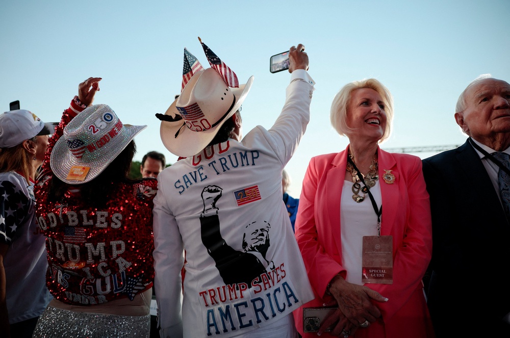 Many of the attendees were spotted wearing Trump-themed clothing, including a jacket that states: 'Trump saves America' (Reuters)