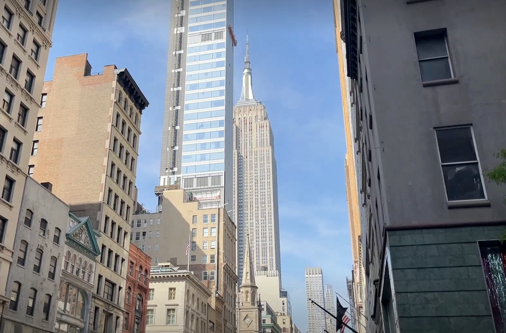 A close-up view of 262 Fifth Avenue and the Empire State Building from Fifth Avenue shows the scale of the luxury apartment building (Zack Palomo / The Independent)