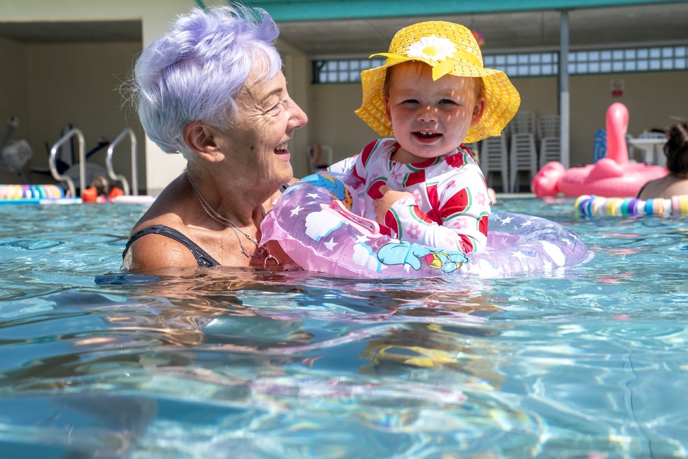Rosie Sloan, 18 months, with her grandmother Sandra Sloan, cools off from the hot weather at Cumnock open-air swimming pool in East Ayrshire (Jane Barlow/PA) (PA Wire)