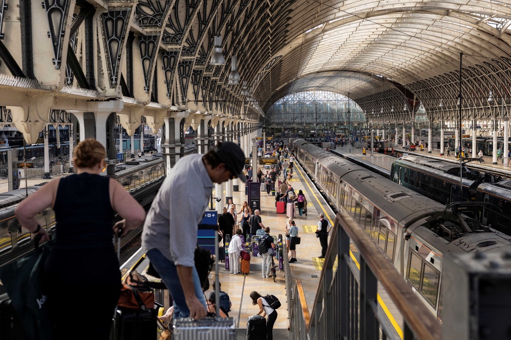 Passengers make their way through Paddington train station in central London (AFP/Getty)
