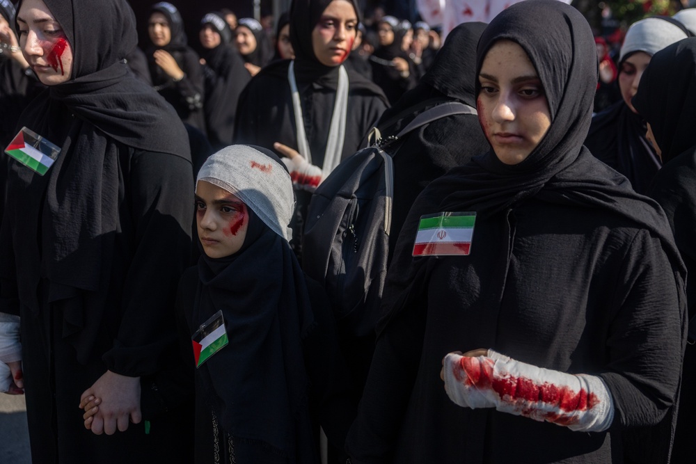 Women with simulated wounds symbolising war victims take part in a mourning procession marking Ashura, the holiest day on the Shi’ite Muslim calendar on June 25, 2026 in Istanbul (Getty)