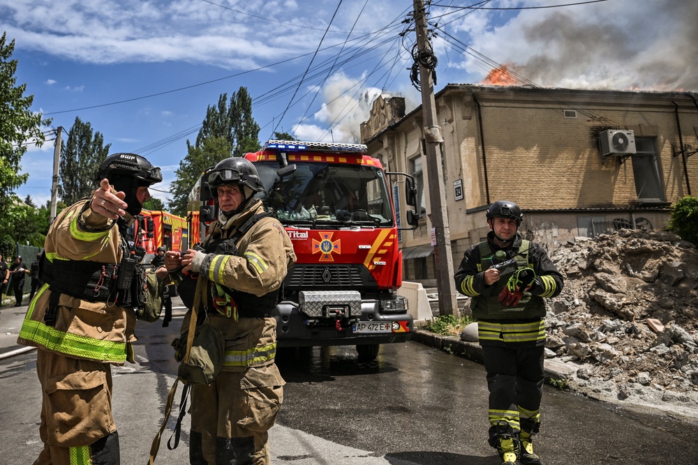 Firefighters work at the site of a Russian military strike, amid Russia's attack on Ukraine, in Zaporizhzhia (Reuters)