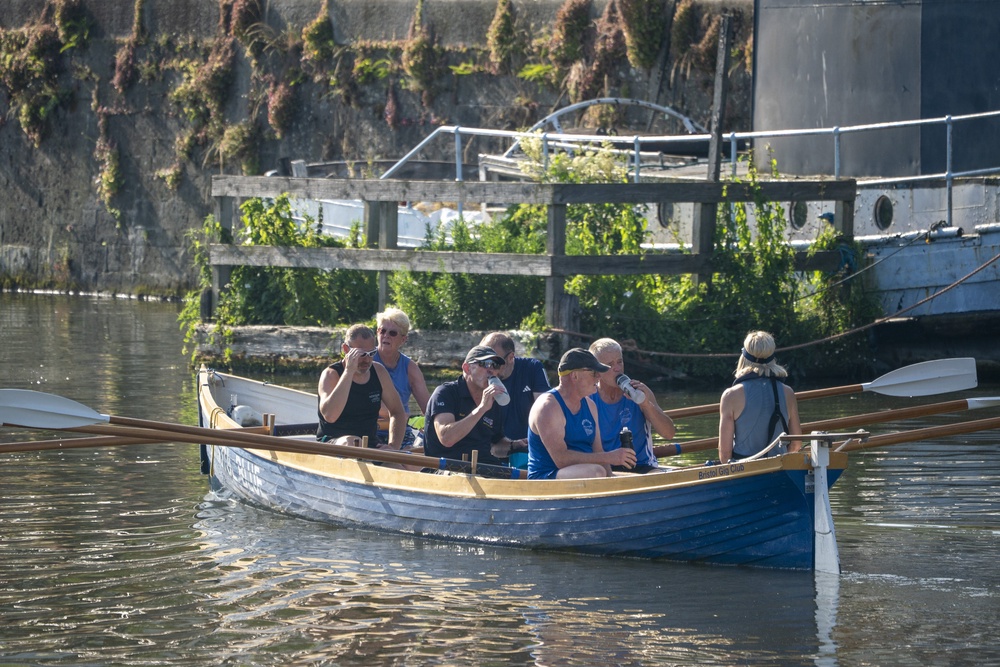 Rowers pause to rehydrate as they take an early morning trip across the harbour in Bristol (Ben Birchall/PA) (PA Wire)
