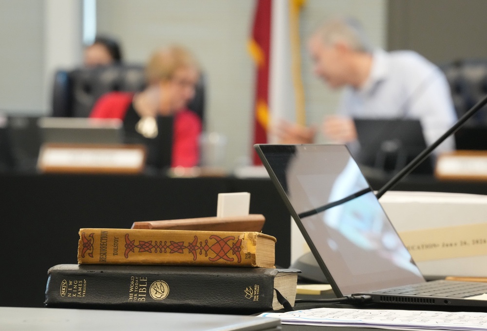A Bible and Resurrection by Leo Tolstoy sit on the desk of State Board of Education member LJ Francis during a meeting on proposed social studies standards in Texas (AP)