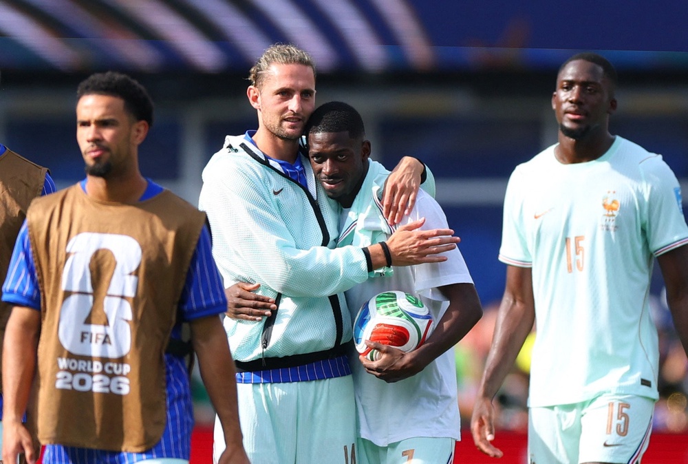 France's Ousmane Dembele celebrates with Adrien Rabiot after picking up the match ball thanks to his hat-trick (Reuters)