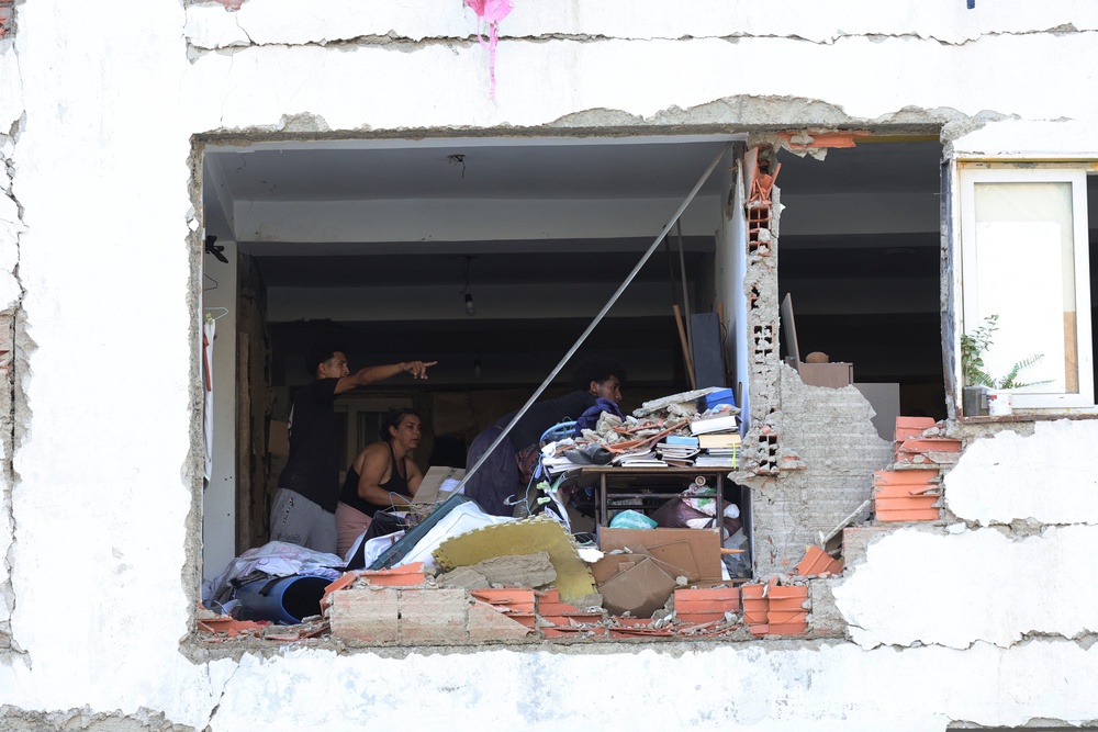 A person searches for victims amid debris (Getty Images)