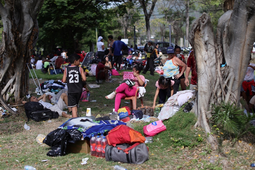 People gather and wait at Caraballeda Golf & Yacht Club as rescue efforts continue (Getty Images)