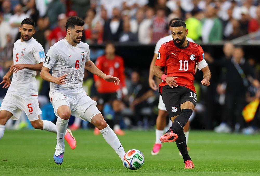 Egypt's Mohamed Salah in action with Iran's Saeid Ezatolahi (Reuters)