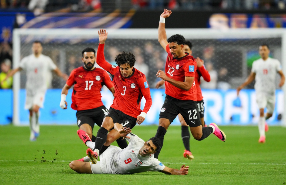 Iran's Mehdi Taremi in action with Egypt's Mohamed Hany and Omar Marmoush (Reuters)