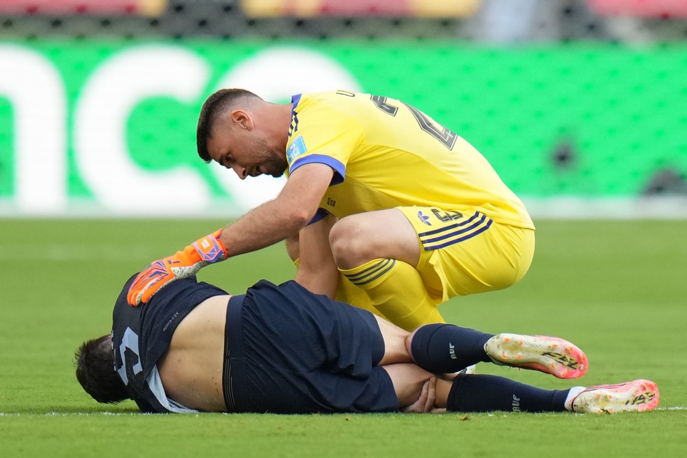 Spain goalkeeper Unai Simon checking on Ugarte (AP)