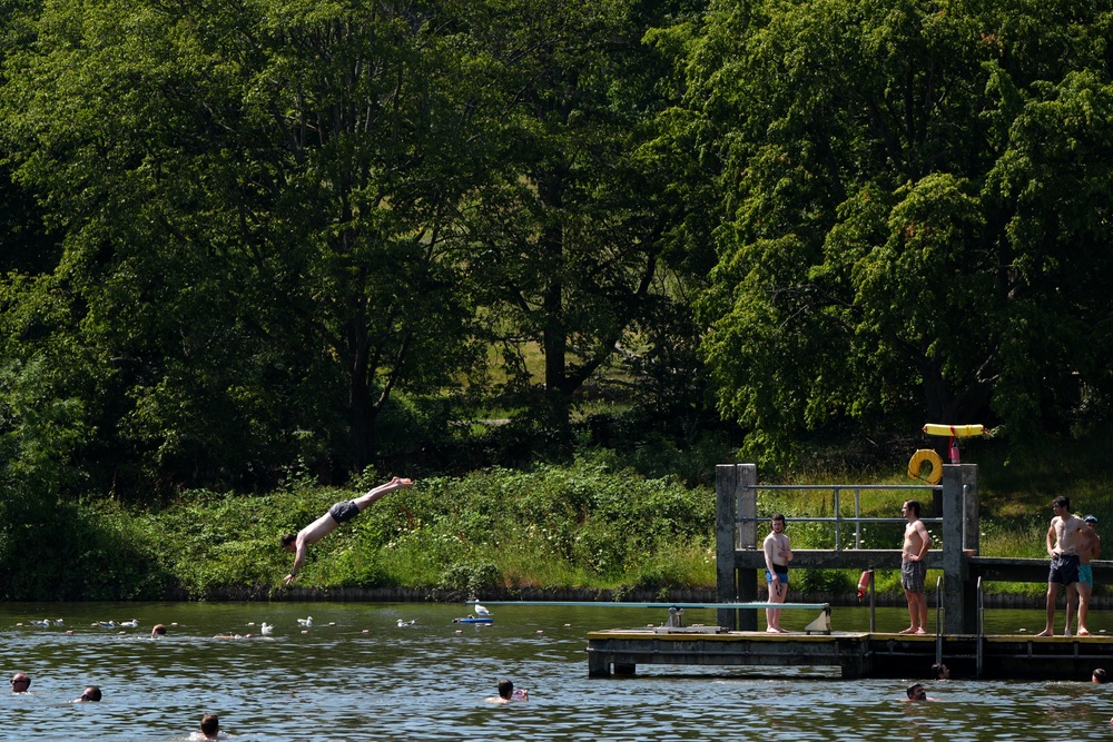 People swim in the lido at Hampstead Heath, London. A rare red warning for extreme heat has been issued by the Met Office (PA)